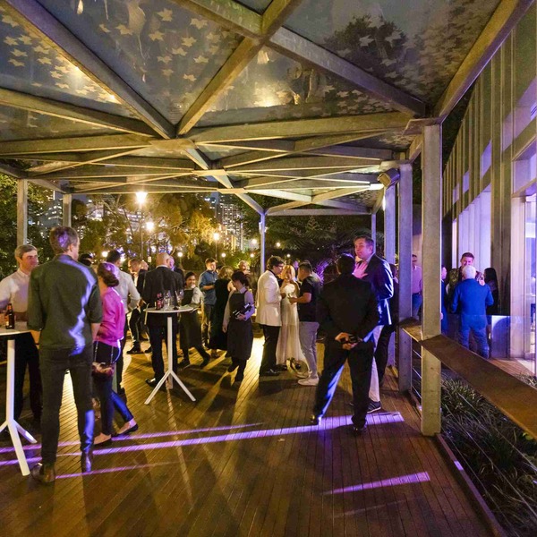 Ericsson guests celebrating together on a wooden deck, creating a vibrant and joyful party atmosphere with laughter and conversation.