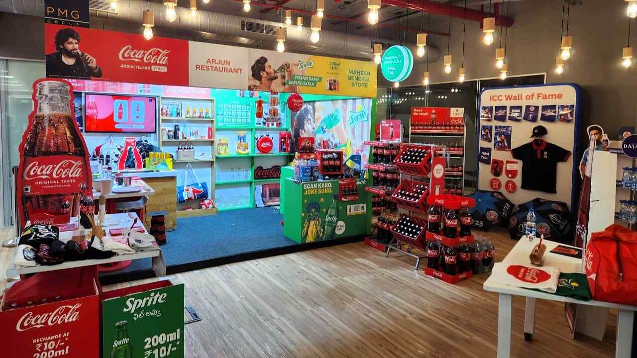 A retail display of various products, prominently featuring a Coca-Cola sign.