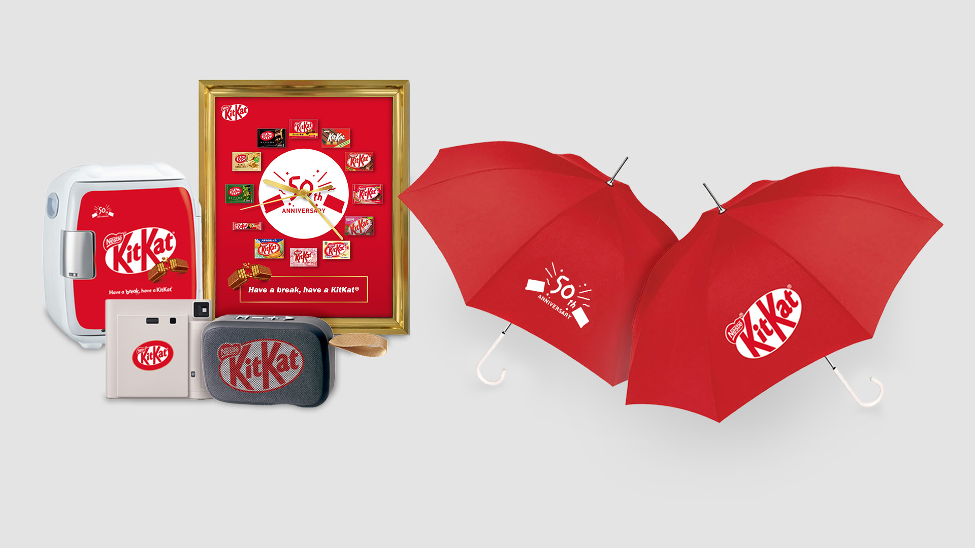 Various KitKat 50th anniversary promo items on a light grey background.