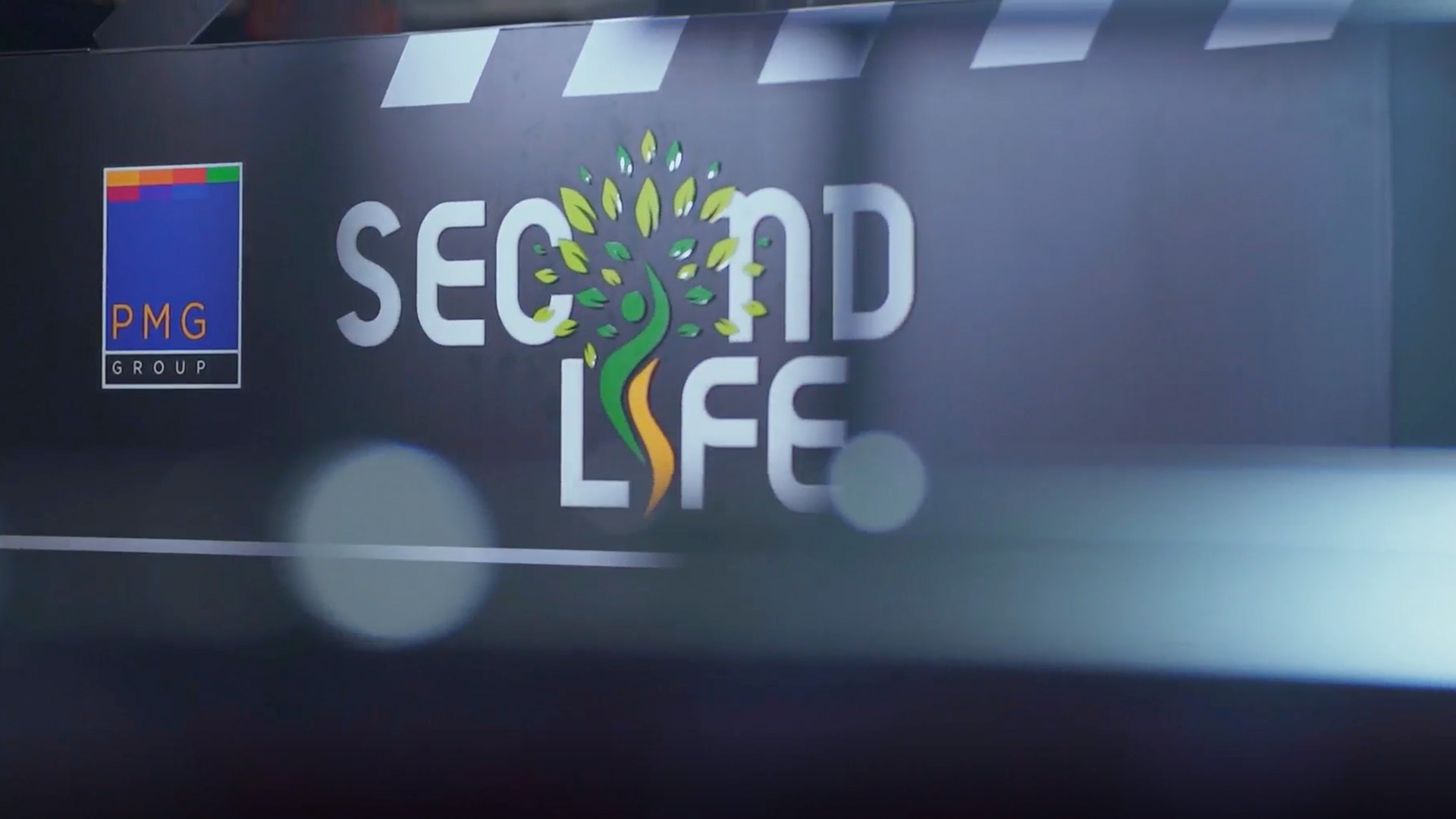 The Second Life logo prominently featured on a large screen.