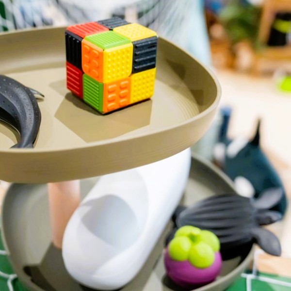 PMG-Thailand-Innovation-Day-2024-2.jpg A display with an array of toys and a cube made from plastic discards (PP, PET and PE).