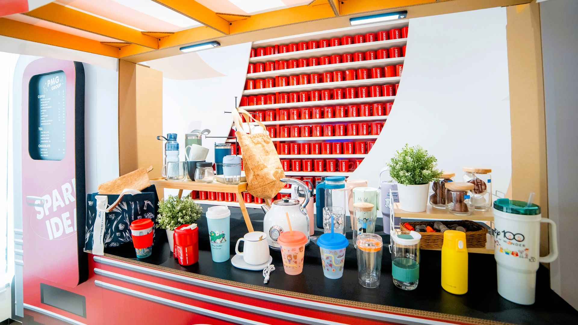 PMG-Thailand-Innovation-Day-2024-5.jpg A red and white counter featuring various tumblers with temperature-sensitive, colour-changing features.