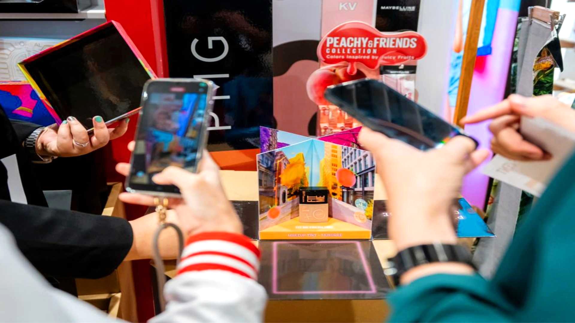 PMG-Thailand-Innovation-Day-2024-6.jpg Several individuals browsing a product showcase and taking photos with their mobile phones.