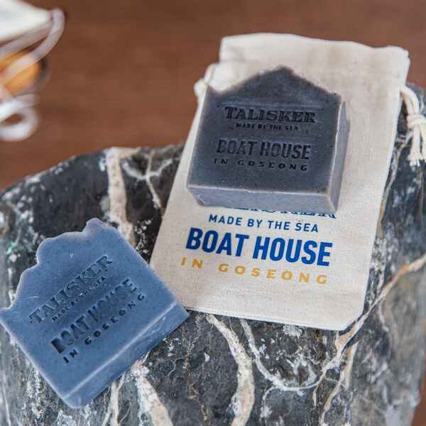 Two soap bars and a small pouch imprinted with Talisker Made by the Sea: Boathouse in Goseong.