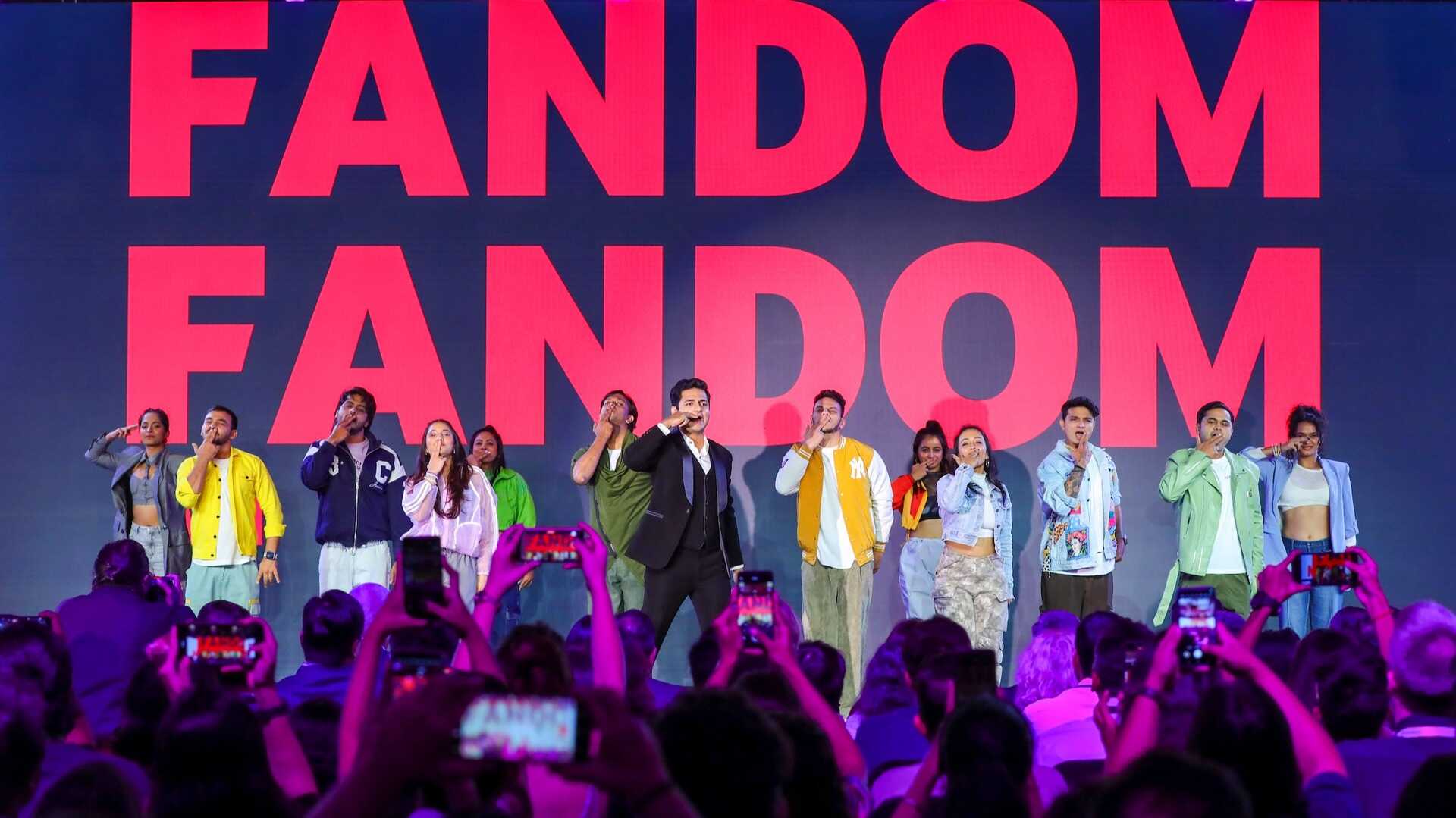 Kenny Sebastian with dynamic performers on stage, with the word Fandom clearly visible in the backdrop.